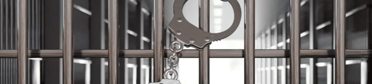 Prison bars with handcuffs